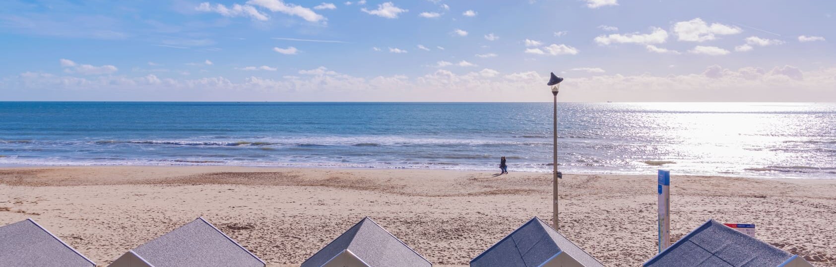 Bournemouth beach huts and sea view on a sunny day Dorset